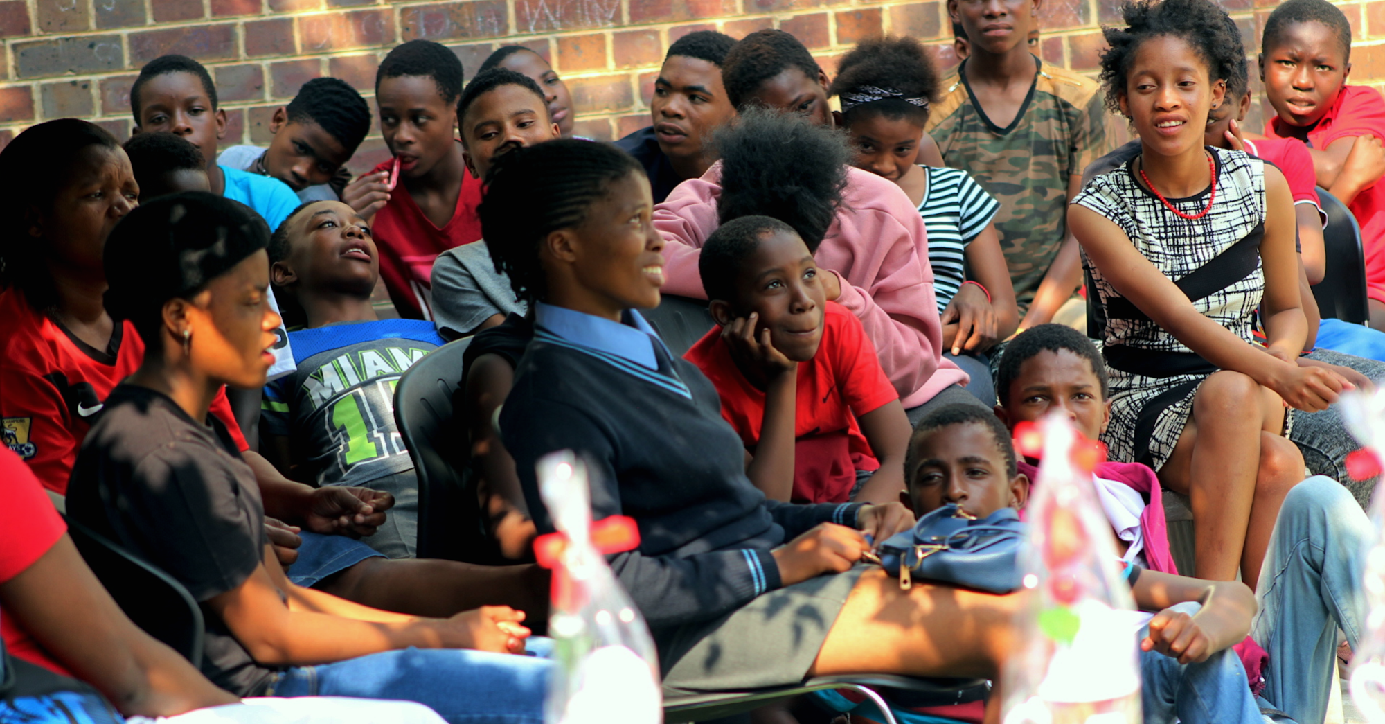 Young South Africans learn about HIV prevention during a school outreach program. 